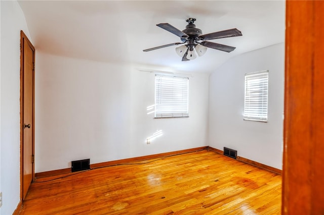 unfurnished room featuring hardwood / wood-style flooring, ceiling fan, and lofted ceiling