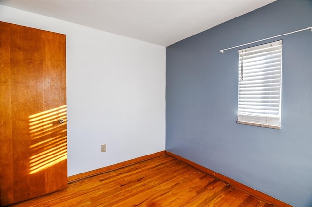 unfurnished room with hardwood / wood-style floors