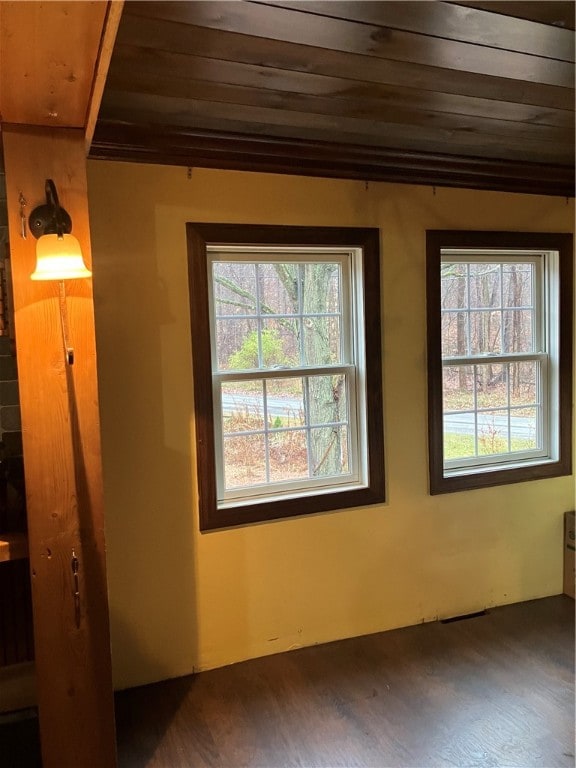 empty room with dark hardwood / wood-style flooring and wood ceiling