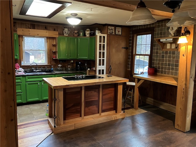 kitchen featuring green cabinets, sink, and plenty of natural light