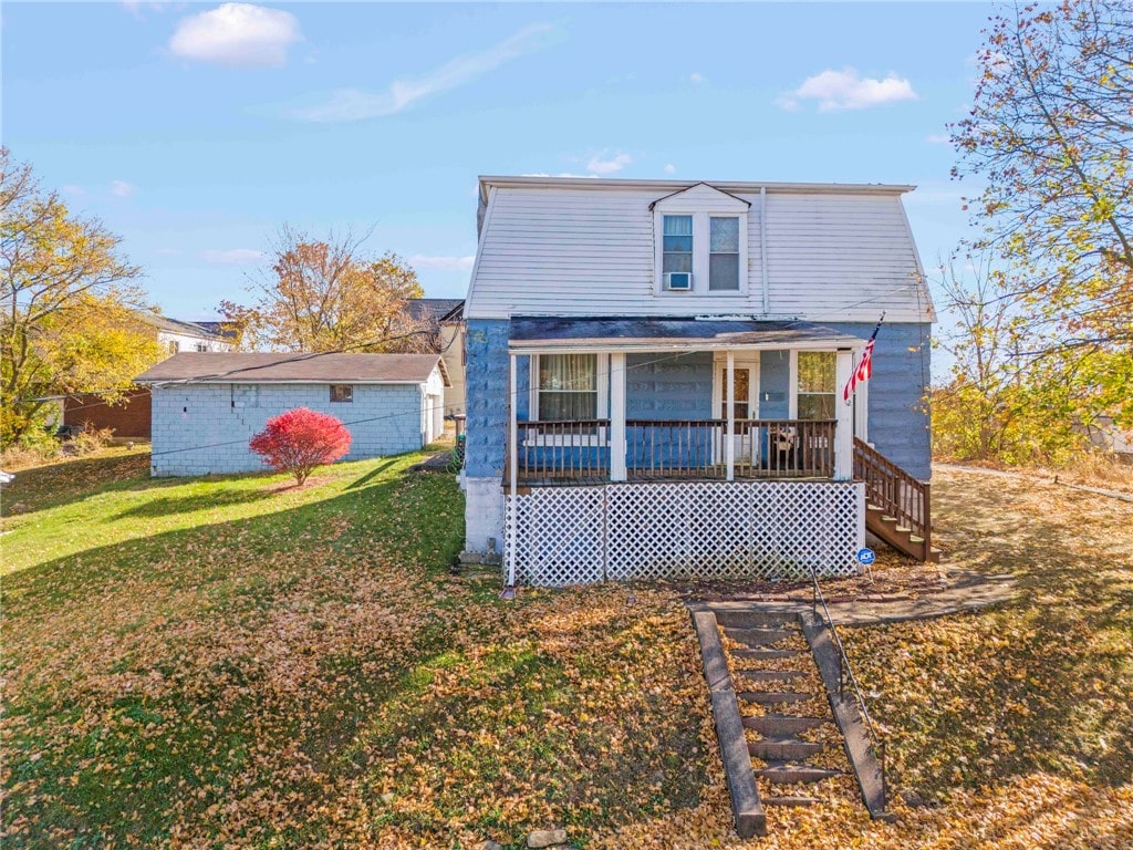 bungalow-style house featuring a porch and a front lawn