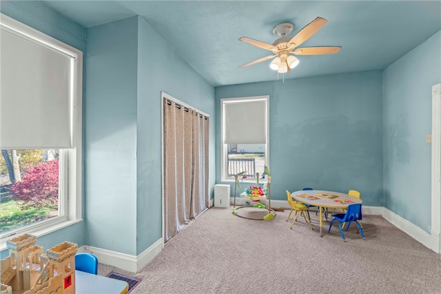 recreation room featuring carpet and ceiling fan