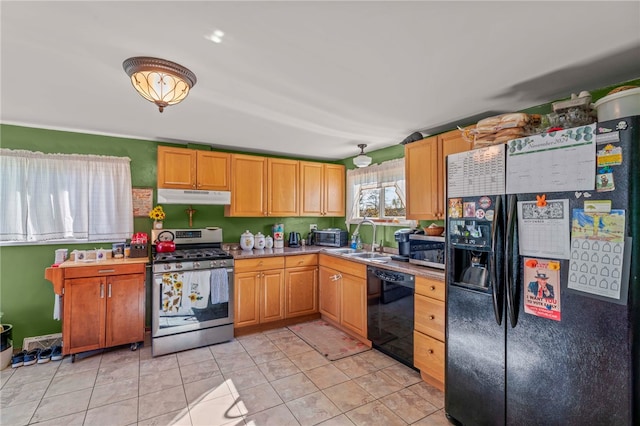 kitchen with black appliances, light tile patterned floors, and sink