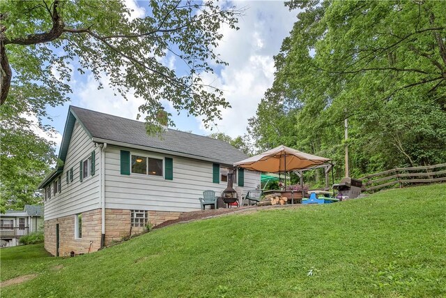 back of house with a lawn, a patio, and a gazebo