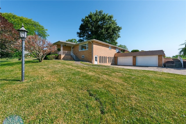 view of front of property with a garage and a front yard