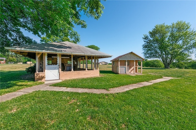 exterior space with an outdoor structure and a lawn