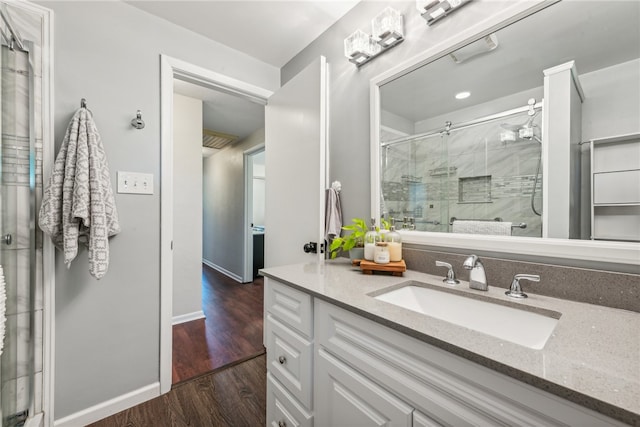 bathroom featuring vanity, an enclosed shower, and hardwood / wood-style floors