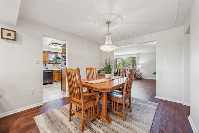 dining room featuring dark hardwood / wood-style floors and a chandelier