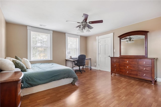 bedroom with light wood-type flooring and ceiling fan