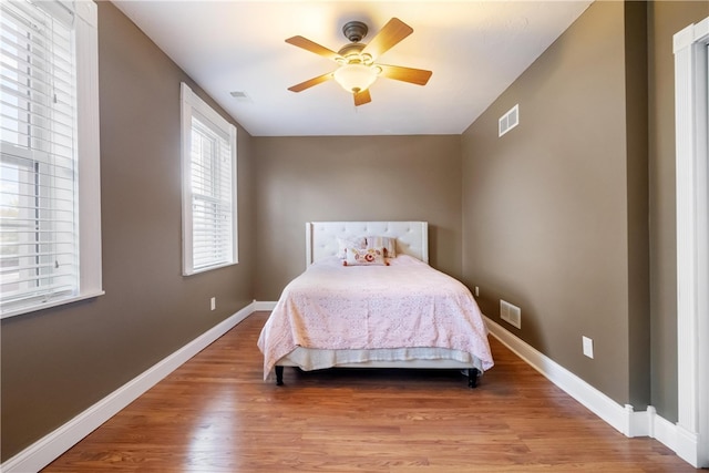 bedroom featuring hardwood / wood-style flooring and ceiling fan