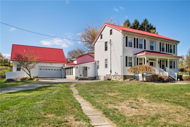 mediterranean / spanish-style home with a garage, covered porch, and a front yard