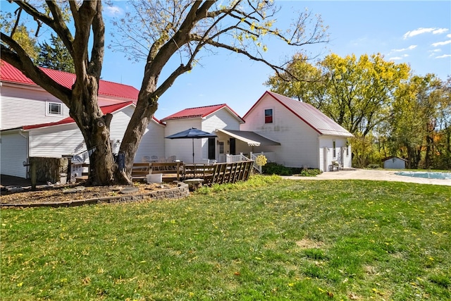 exterior space with a patio area, a front yard, and a pool