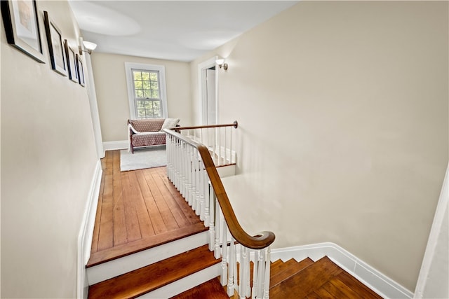 stairway with hardwood / wood-style flooring