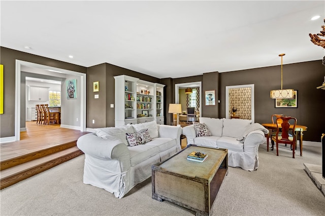 living room featuring light hardwood / wood-style floors and an inviting chandelier