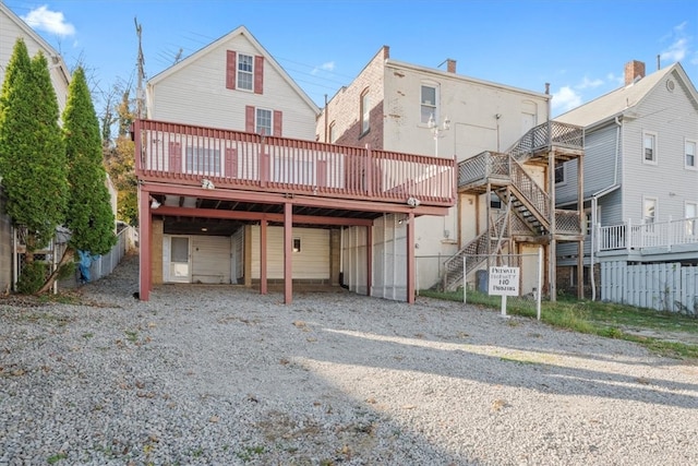 back of property featuring a wooden deck