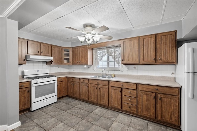 kitchen with decorative backsplash, light tile patterned floors, sink, ceiling fan, and white appliances