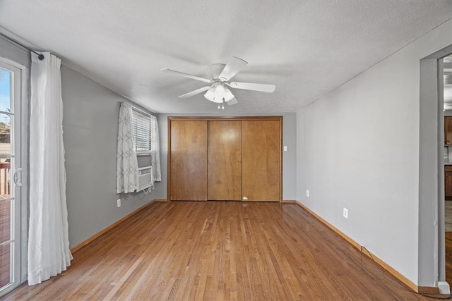 unfurnished bedroom featuring a closet, ceiling fan, a textured ceiling, and light hardwood / wood-style floors