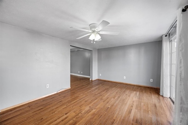 unfurnished room featuring a textured ceiling, light hardwood / wood-style floors, and ceiling fan