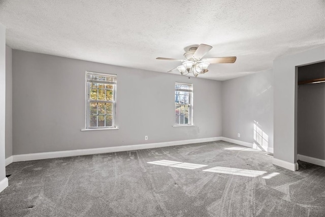 unfurnished bedroom with ceiling fan, a textured ceiling, and carpet flooring