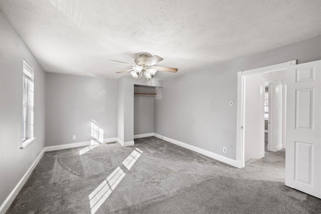 unfurnished bedroom with ceiling fan, a textured ceiling, and carpet