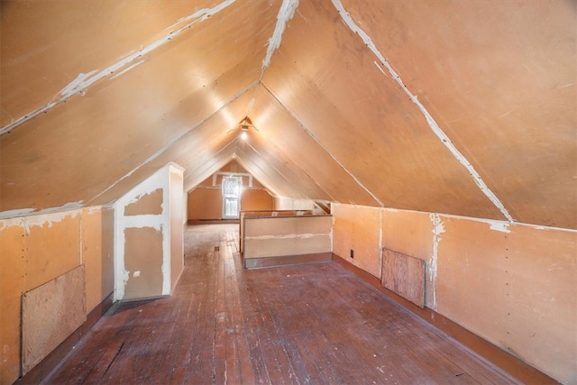 additional living space featuring hardwood / wood-style flooring and vaulted ceiling