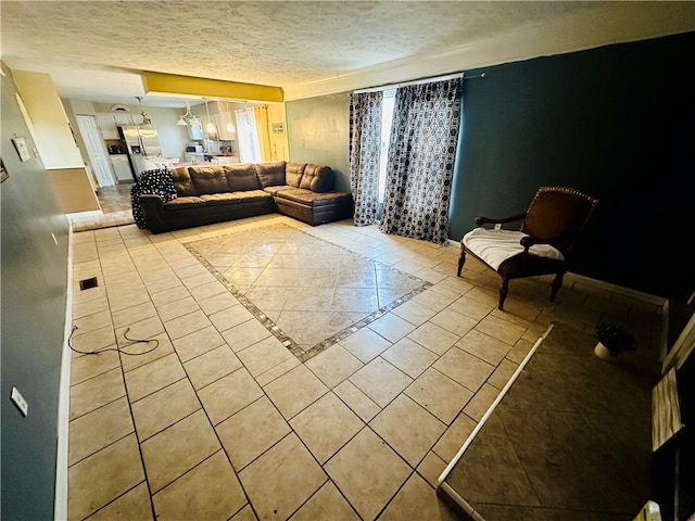 living room with light tile patterned floors and a textured ceiling