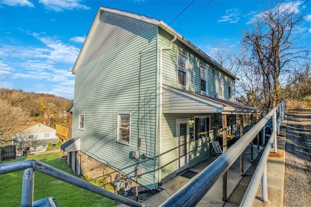 view of side of home featuring a lawn