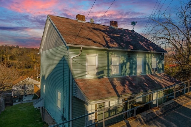 view of back house at dusk