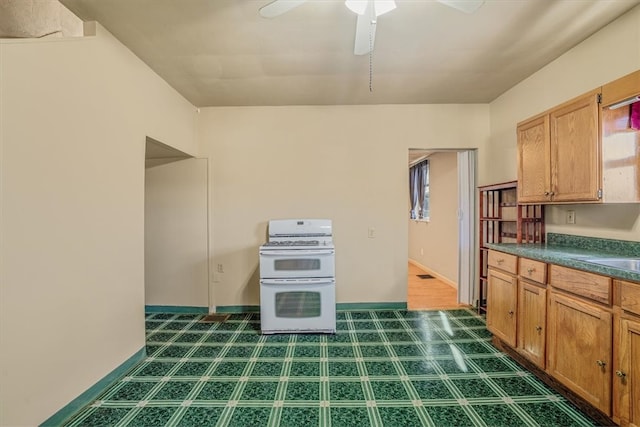 kitchen featuring white stove and ceiling fan