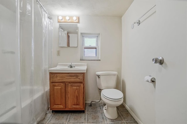 bathroom featuring vanity, toilet, and a textured ceiling