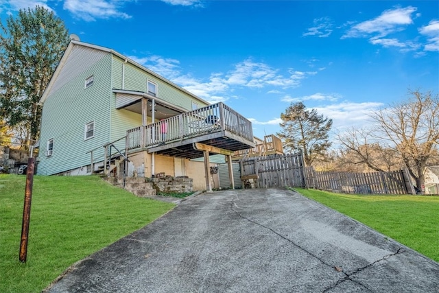 view of side of home featuring a yard and a deck