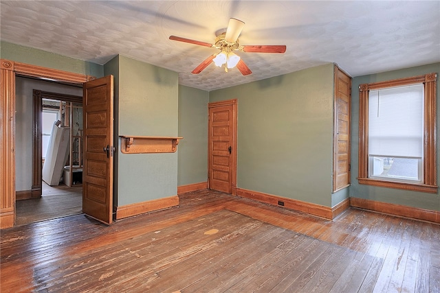 spare room featuring a textured ceiling, hardwood / wood-style flooring, and ceiling fan