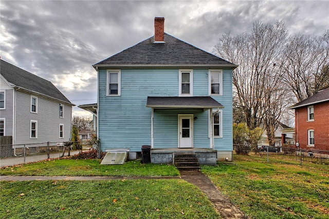 back of house featuring a yard