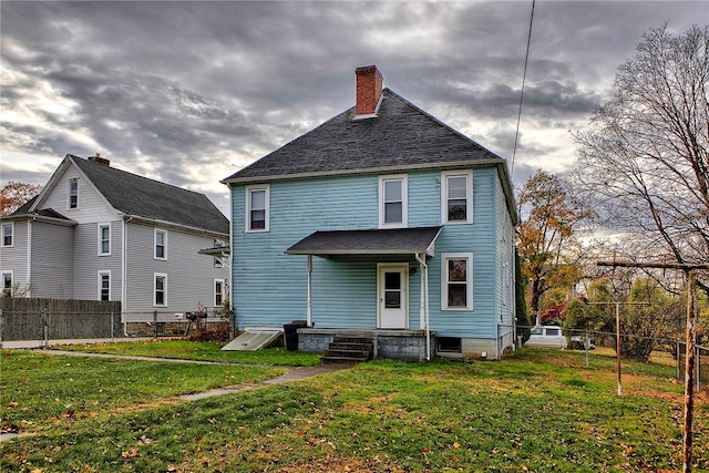 back of house featuring a lawn