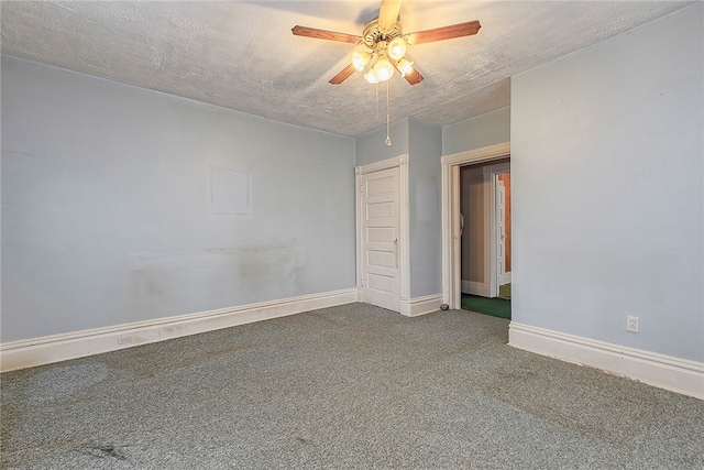 carpeted spare room with a textured ceiling and ceiling fan