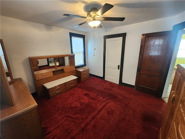 carpeted bedroom featuring ceiling fan and multiple windows