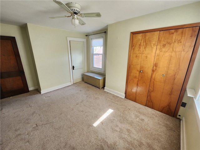 unfurnished bedroom with a closet, light colored carpet, and ceiling fan