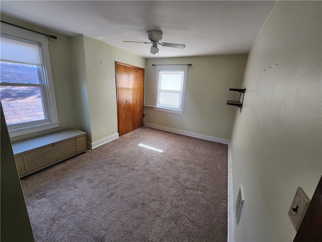 unfurnished bedroom featuring ceiling fan, a closet, and carpet floors