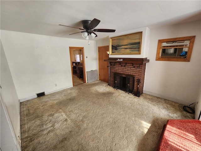 living room featuring carpet flooring, a fireplace, and ceiling fan