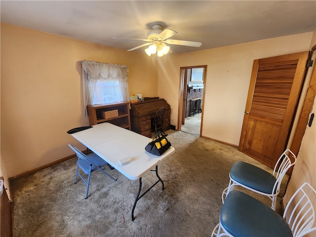 office area featuring ceiling fan and dark carpet