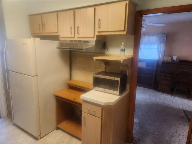 kitchen with ventilation hood, white fridge, light brown cabinets, decorative backsplash, and ceiling fan