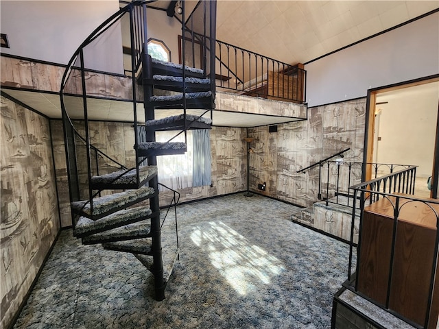 staircase featuring carpet flooring and a high ceiling