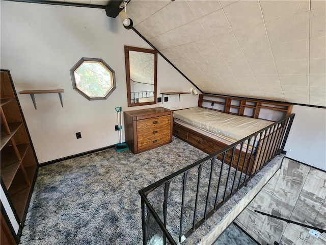 bedroom featuring carpet and lofted ceiling with beams