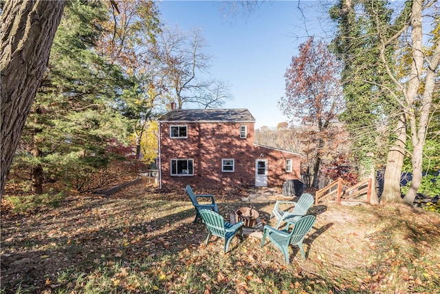 back of house with an outdoor fire pit