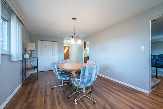 dining area featuring dark hardwood / wood-style flooring and a notable chandelier