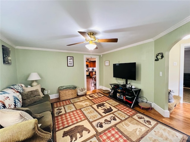 living room featuring crown molding, hardwood / wood-style flooring, and ceiling fan