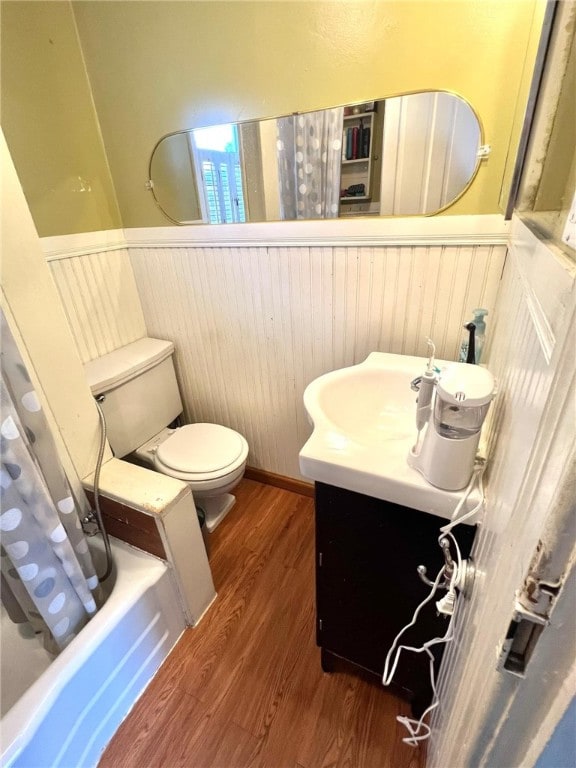 full bathroom with toilet, shower / bath combo, vanity, and wood-type flooring