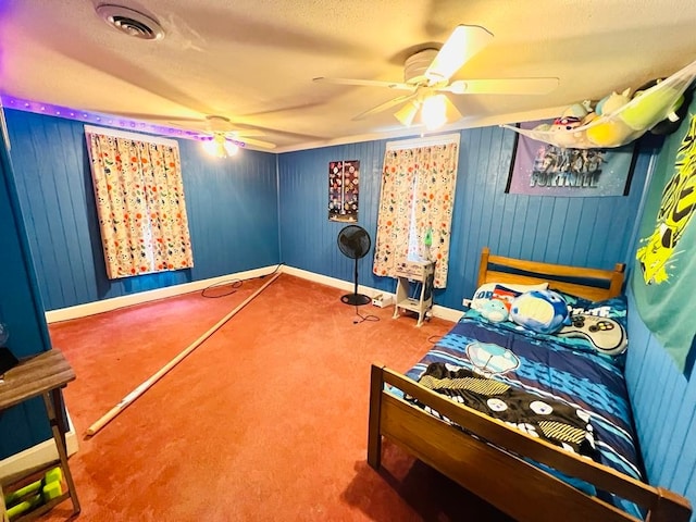 bedroom featuring a textured ceiling, carpet, and ceiling fan