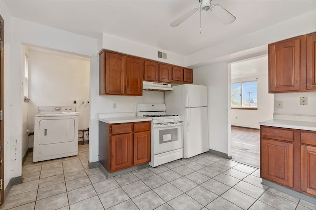 kitchen with washer / clothes dryer, white appliances, light tile patterned flooring, and ceiling fan