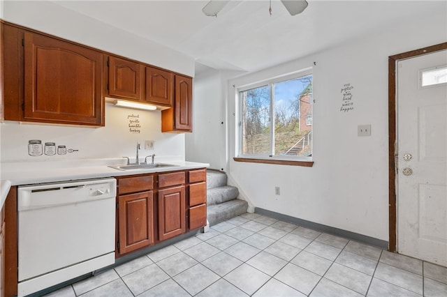 kitchen featuring light tile patterned flooring, ceiling fan, a wealth of natural light, and white dishwasher